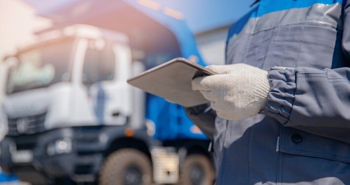 Truck driver signing paper
